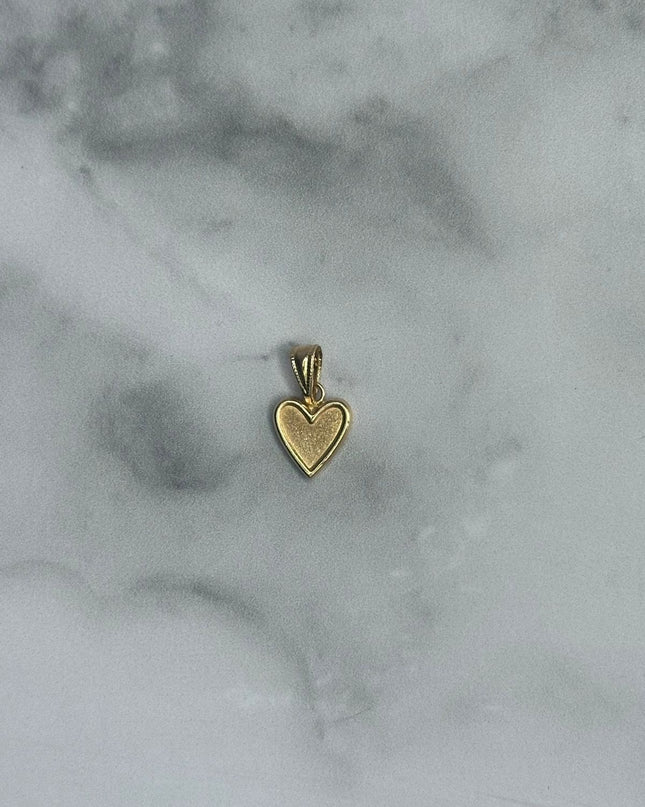 Dije corazon liso con borde / 0,63 Gr / Oro amarillo 18k