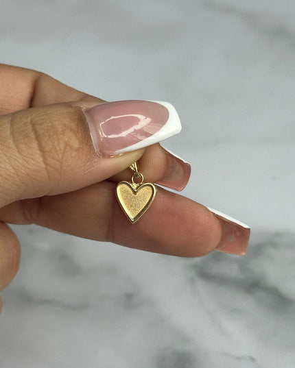 Dije corazon liso con borde / 0,63 Gr / Oro amarillo 18k
